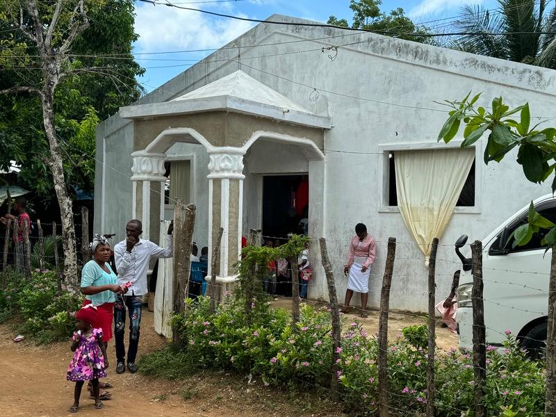 A church building and some poeple.