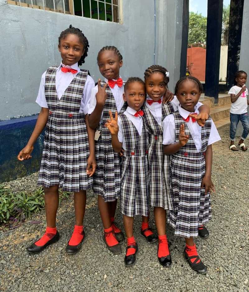 A group of girls dressed in the same clothes.
