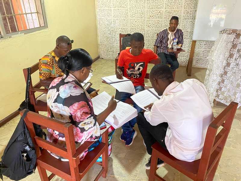 A group of adults studying in a circle
