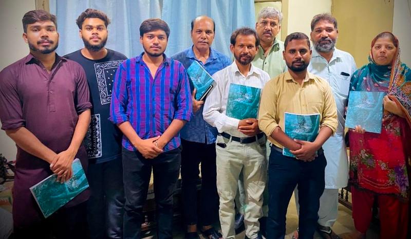 A group of Pakistanian people holding training materials