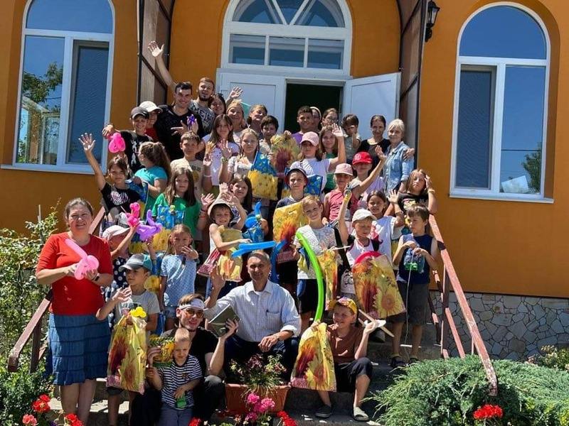 A group of children in front of a church